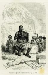Ketimkuru, stamhoofd, spelend op de accordeon. Gravure door Riou ter illustratie van het verhaal "De meren van Equatoriaal-Afrika" van Victor Giraud, adelborst, in 1883-1885, in Le Tour du monde, 1886, onder leiding van Édouard Charton (1807-1890)