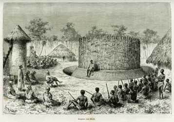 Ontvangst bij Mkwewe, stamhoofd, met de verteller. Gravure door Riou ter illustratie van het verhaal 