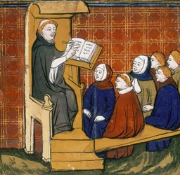 Dominicaanse leraar, zittend met boek op een lessenaar, met leerlingen zittend op de grond voor hem. "Livre des Proprietez des Choses", begin vijftiende eeuw
