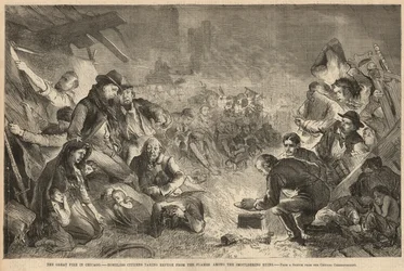 Dakloze burgers zoeken toevlucht voor de vlammen tussen de smeulende ruïnes