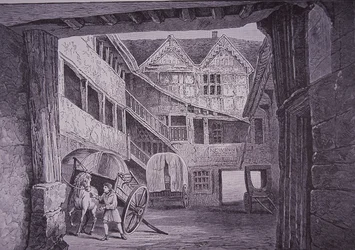 Staljongen verzorgt paard in binnenplaats van de New Inn, Gloucester