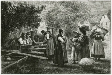 Een wasplaats in Metzeral, vrouwen in traditionele vallei-kostuums verzamelen zich bij de dorpsfontein. Gravure door E. Ronjat, ter illustratie van het verhaal 
