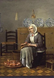 Een zittende vrouw die voedsel bereidt in een keuken