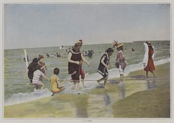 Kinderen spelen met een touw op het strand