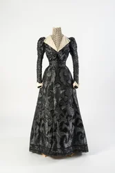 Zwart zijden jurk met hoge hals chemisette van crèmekleurig kant, vroege jaren 1890