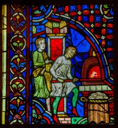 Glas-in-loodraam dat bakkers in de Middeleeuwen toont die brood bakken in een oven