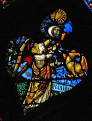 Het westelijke roosvenster met een scène uit het Boek Openbaring: vierde trompet zon, maan en sterren verduisteren, en de adelaar als de engel die Wee, Wee roept, eronder geschreven (8:12-13)