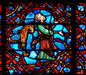 Raam w12 met een scène in het Barmhartige Samaritaan raam: de Samaritaan stapt van zijn paard