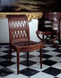 Stoel besteld voor de zuivelboerderij van Marie Antoinette. Gesneden mahoniehouten meubel door Georges Jacob (1739-1814)