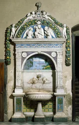 Gedecoreerde fontein met een hoog reliëf in marmer en terracotta door Giovanni della Robbia (1469-1529) 1498. Sacristie van Santa Maria Novella, Florence