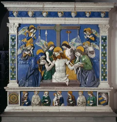 De Graflegging van Jezus in het Heilig Graf met de Maagd en Sint Johannes Evangelist. Weergave van symbolen van het Lijden: zwepen, doornenkroon en spons gedrenkt in azijn (posca). Hoog reliëf keramiek door Giovanni della Robbia (1469-1529) circa 14