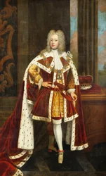 Portret van koning George II als prins van Wales, ten voeten uit, gekleed in staatsgewaden en de kraag van de Orde van de Kousenband, met zijn zwaard in zijn linkerhand en zijn kroon op een tafel naast hem, in een interieur