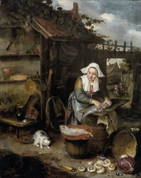 Een huisvrouw in een binnenplaats die vis schoonmaakt