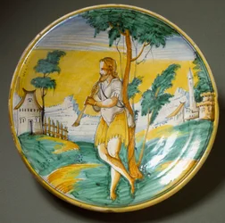 Fluitspeler in een landschap. Keramische plaat geproduceerd in Viterbo, Italië. Eind 16e eeuw
