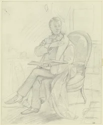 Jonge man zittend in een fauteuil met een boek