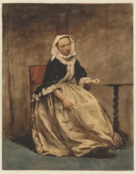 Zittende vrouw naast een kleine tafel