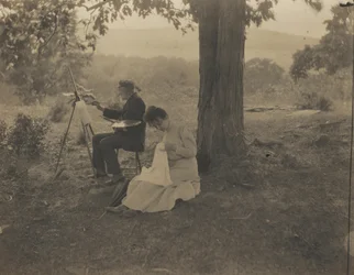 Naaiende vrouw, schilderende man,1900 (foto)