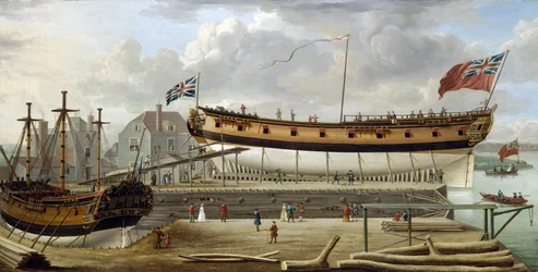 Een zesdeklasser, een oorlogsschip van de Britse Koninklijke Marine, in droogdok, de scheepswerf is waarschijnlijk die van Rotherhite, aan de zuidelijke oever van de Theems, Engeland