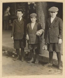 [Three Boys on City Street in Knickers and Caps].