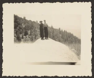 [Figures Standing on Rock].