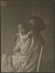 [Moeder die baby in stoel vasthoudt]