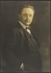 [Portret van een staande man met zijn hand in zijn zak]