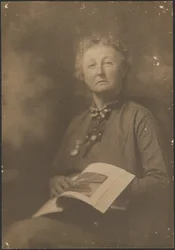 [Woman Holding Magazine].
