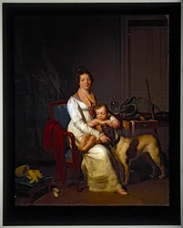 Een jonge dame met een kind en hond in een interieur