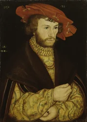 Portret van een bebaarde jonge man met rode baret