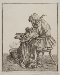 Een vrouw warmt zich