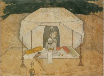 Balwant Singh zittend schrijvend op een veldbed