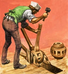 Er was eens... dorpsleven honderd jaar geleden. Een wagenmaker aan het werk