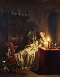 Een interieur bij kaarslicht met een dame zittend aan een tafel