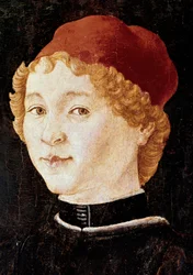 Portret van een jonge man met een rode hoed