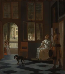Man geeft een brief aan een vrouw in de hal van een huis