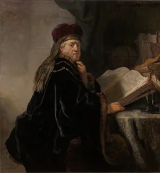 Een geleerde zittend aan een bureau