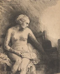 Vrouw in bad met een hoed naast haar