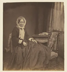 [Portret van een zittende vrouw met muts]