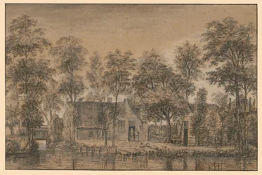 Boerderij onder bomen bij het kanaal