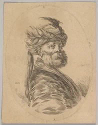 Een Turkse man met een baard en tulband met een lange veer aan de voorkant