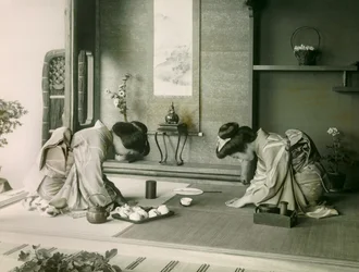 Twee Japanse vrouwen in traditionele klederdracht begroeten elkaar voor de theeceremonie, circa 1900 - 1915 (foto)