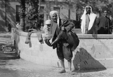 Een waterdrager in Damascus, Syrië