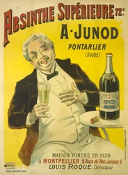 Een man die op een terras van een café zit en in lachen uitbarst terwijl hij een glas absint drinkt