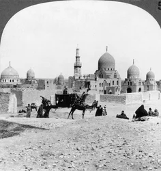 Een schip van de woestijn passeert graven van vroegere moslimheersers, Caïro, Egypte, 1905
