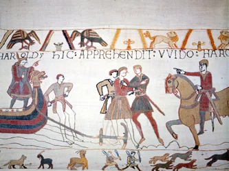 Harold II landde in Normandië waar hij werd gevangengenomen door Willem I de Veroveraar. Tapijt van Bayeux, bekend als Borduurwerk van Koningin Mathilde