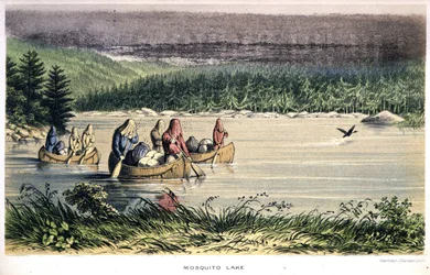 Muggenmeer in Canada: Indianen kanoën over het meer met muggennetten op het hoofd - in 