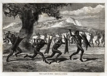 De Obbos (stam van Oeganda) voeren een krijgsdans uit. Gravure ter illustratie van de reis naar het Albertmeer, in 1861-1864, door Sir Samuel White Baker, in 