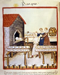 Zwart brood: een bakker aan het werk voor een oven. Miniatuur uit het boek over geneeskunde en diëtetiek, “Tacuinum sanitatis”.