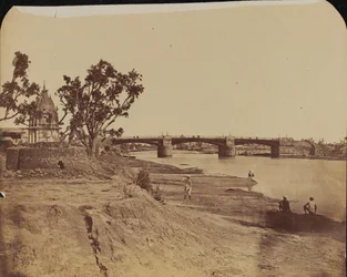 IJzeren brug met stenen pijlers, met burgers op de voorgrond, Gumti-rivier, Lucknow
