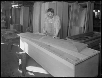 Werker die een stuk van een kistdeksel past, Oneida, New York, 3 april 1916